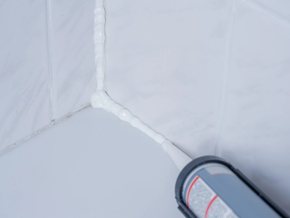 worker applying grout sealant